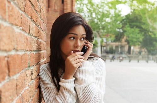 Scared Woman on Phone iStock SensorSpot