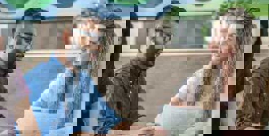 Man and woman conversing over documents in an office